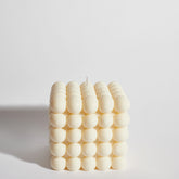 Huge bubble decorative candle front view – modern cream cube design with rounded bubble texture.